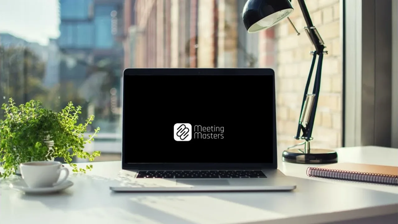 The manifesto film open on a laptop on a desk by the window