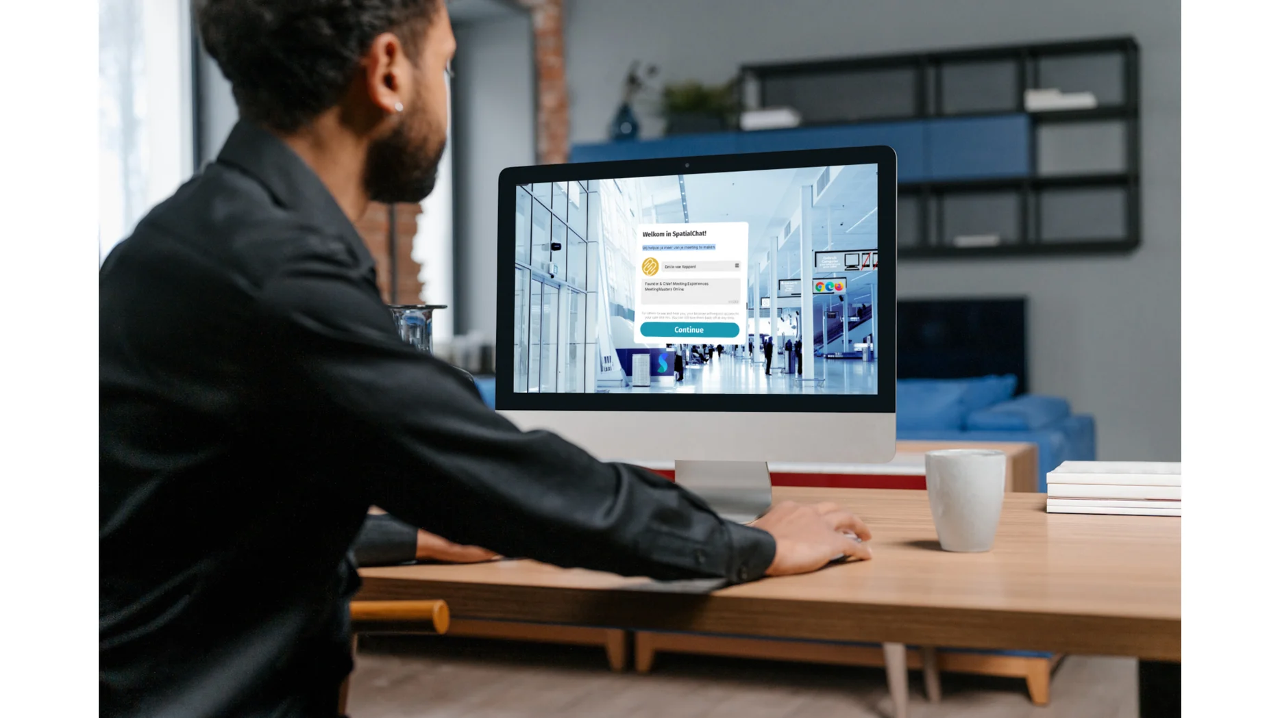 Deelnemer aan een SpatialChat-bijeenkomst logt in op een groot scherm en ziet de virtuele ruimte al voor zich